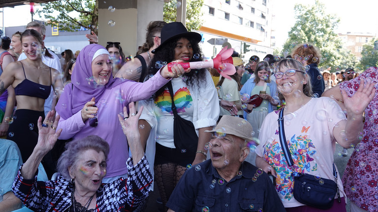 Eine Gruppe fröhlicher Menschen unterschiedlichen Alters mit einer Seifenblasenmaschine beim Besuch des Christopher Street Days in Berlin 2026 vom Immanuel Seniorenzentrum Schöneberg. Eine Gruppe fröhlicher Menschen unterschiedlichen Alters mit einer Seifenblasenmaschine beim Besuch des Christopher Street Days in Berlin 2026 vom Immanuel Seniorenzentrum Schöneberg.